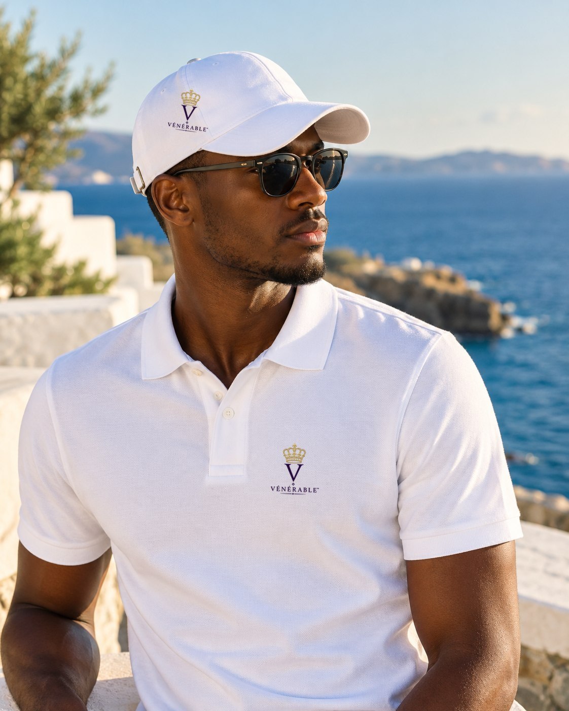 Casquette blanche VÉNÉRABLE au monogramme V couronné brodé, portée en bord de mer